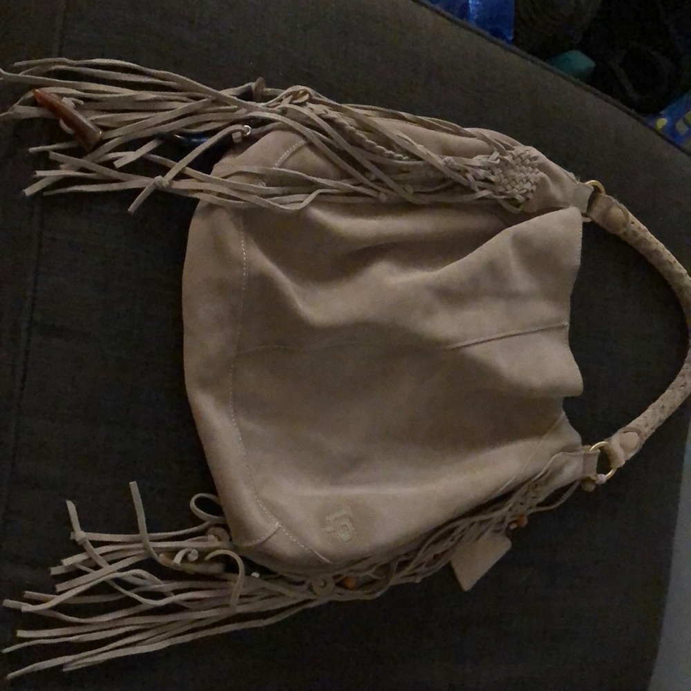 Gray purse by linea Pelli. Very in with the fringes